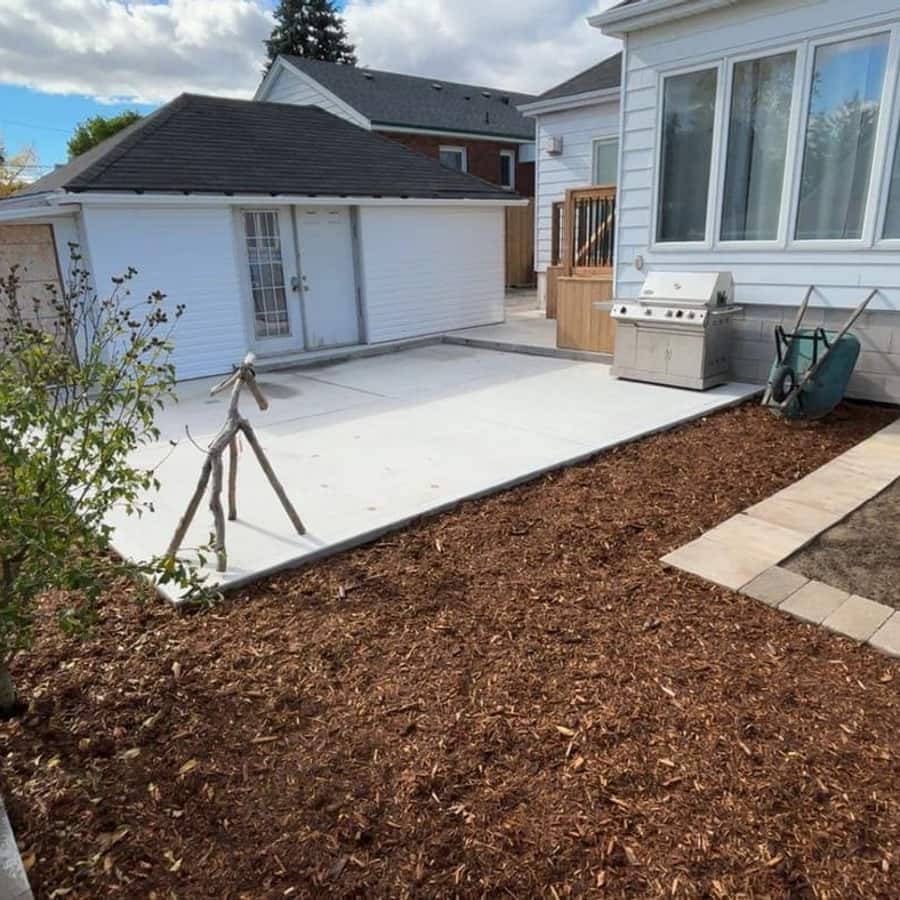 Backyard with new shed, deck and concrete patio at golden hour, built by NEW BUILD CONSTRUCTION in Hamilton, Ontario