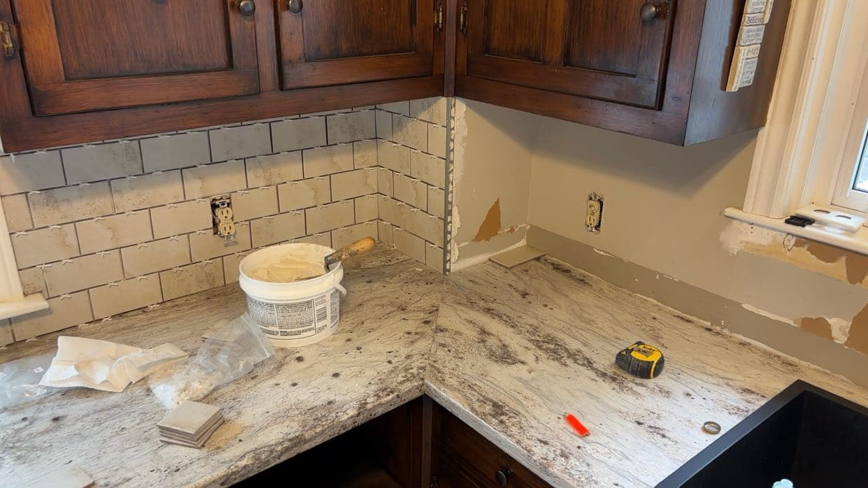 Kitchen subway tile backsplash installation in progress